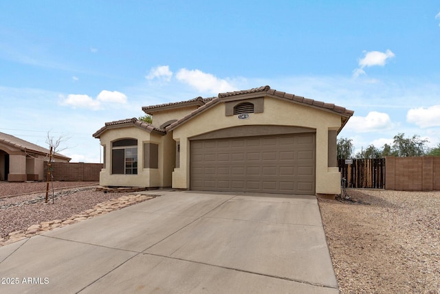 13438 N 130th Ln, El Mirage, AZ 85335 - mediterranean / spanish-style house featuring a garage, concrete driveway, stucco siding, and a tiled roof