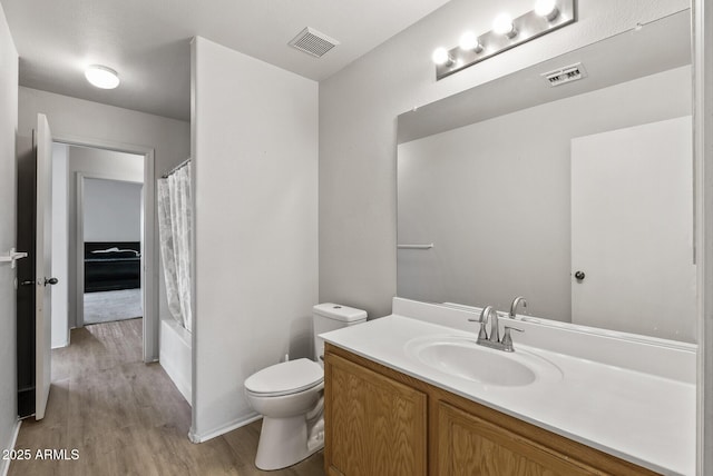 13438 N 130th Ln, El Mirage, AZ 85335 - bathroom featuring wood finished floors, vanity, toilet, and shower / bath combo with shower curtain