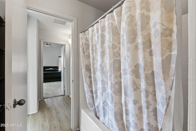 13438 N 130th Ln, El Mirage, AZ 85335 - bathroom featuring wood finished floors and shower / tub combo with curtain