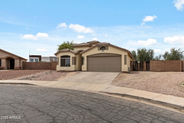 13438 N 130th Ln, El Mirage, AZ 85335 - mediterranean / spanish-style house featuring stucco siding, a tiled roof, a garage, and driveway