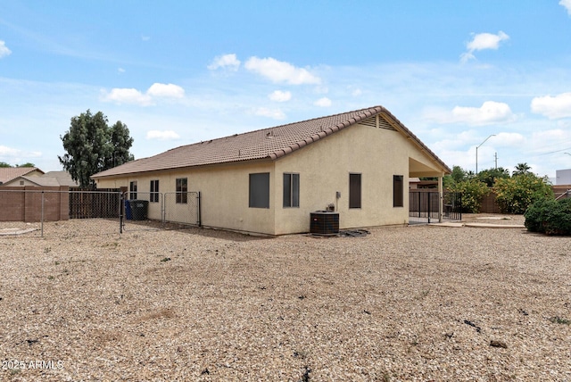 13438 N 130th Ln, El Mirage, AZ 85335 - back of house with a tiled roof, a gate, a fenced backyard, and stucco siding
