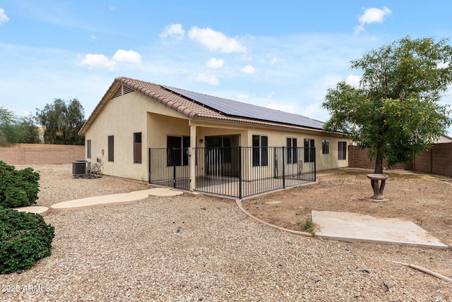13438 N 130th Ln, El Mirage, AZ 85335 - rear view of property with a fenced backyard, a patio area, roof mounted solar panels, and stucco siding