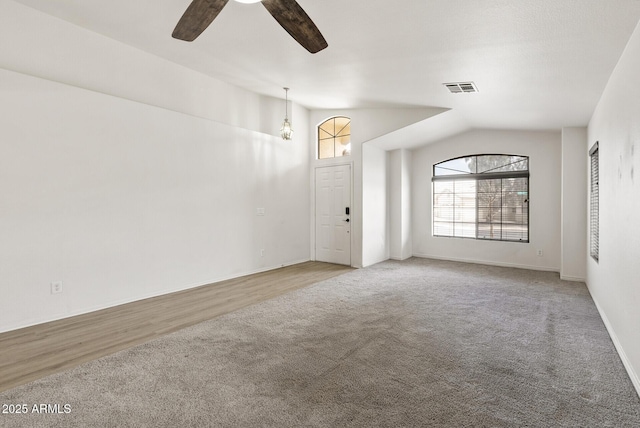 13438 N 130th Ln, El Mirage, AZ 85335 - carpeted empty room featuring lofted ceiling, plenty of natural light, ceiling fan, and baseboards