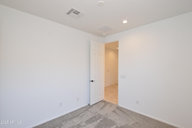 unfurnished room with light carpet, recessed lighting, visible vents, and baseboards