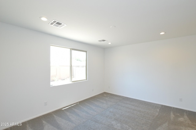 carpeted spare room with recessed lighting, visible vents, and baseboards