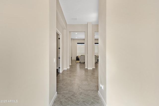 corridor with visible vents and baseboards