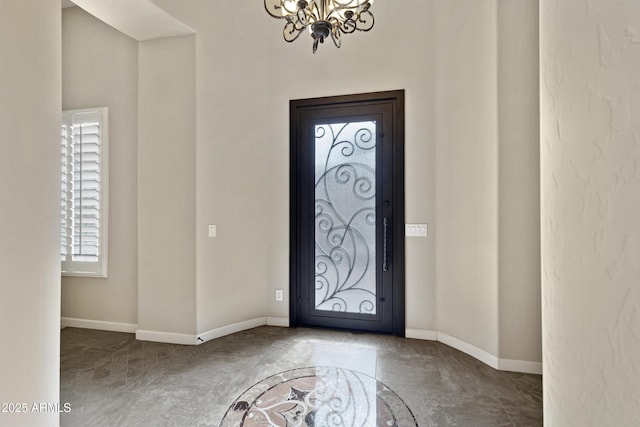 entrance foyer featuring an inviting chandelier and baseboards