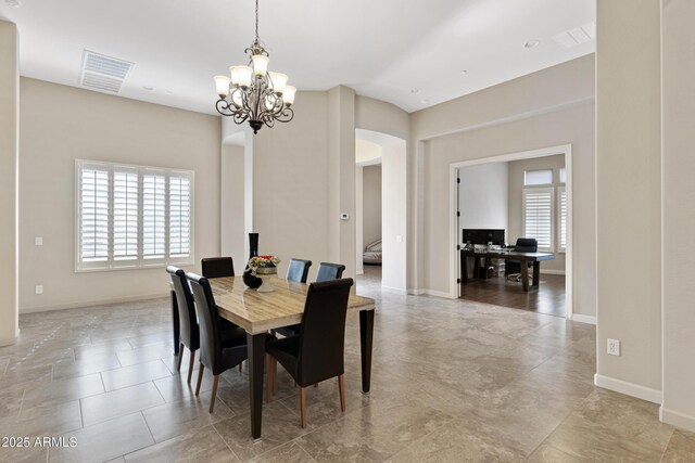 dining space with a chandelier, visible vents, and baseboards