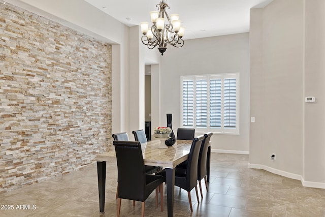 dining space with baseboards, light tile patterned floors, and a notable chandelier