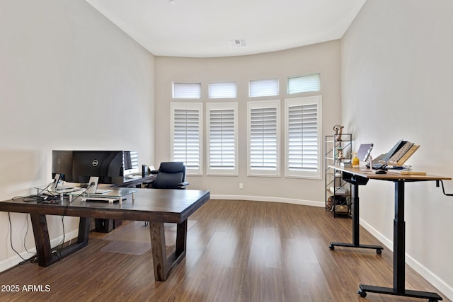 home office with baseboards, visible vents, and wood finished floors