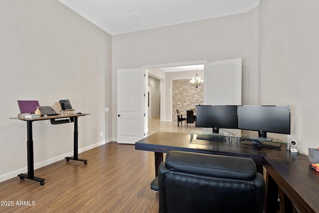 home office featuring baseboards, a chandelier, and wood finished floors