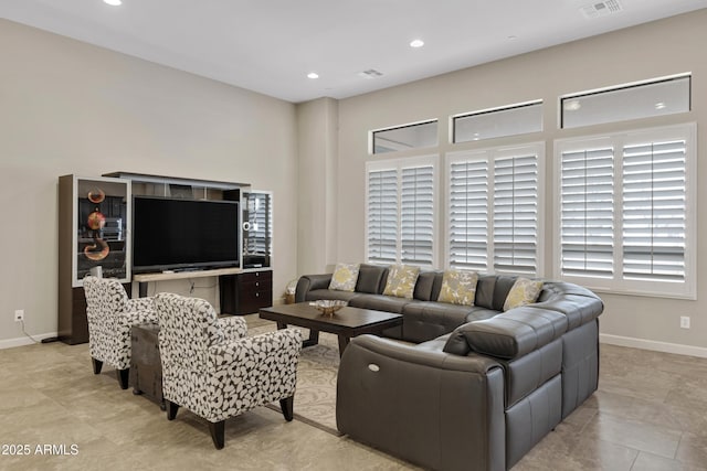 living room with baseboards, visible vents, and recessed lighting