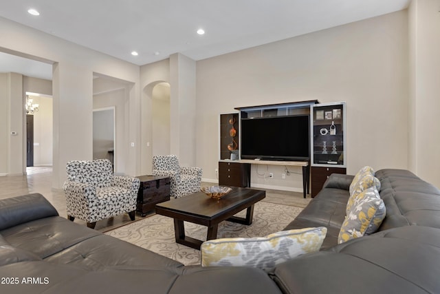 living room featuring arched walkways and recessed lighting