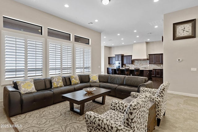 living area featuring visible vents, baseboards, and recessed lighting