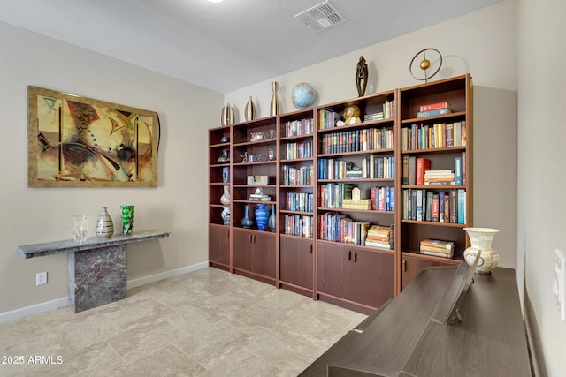 living area featuring visible vents and baseboards