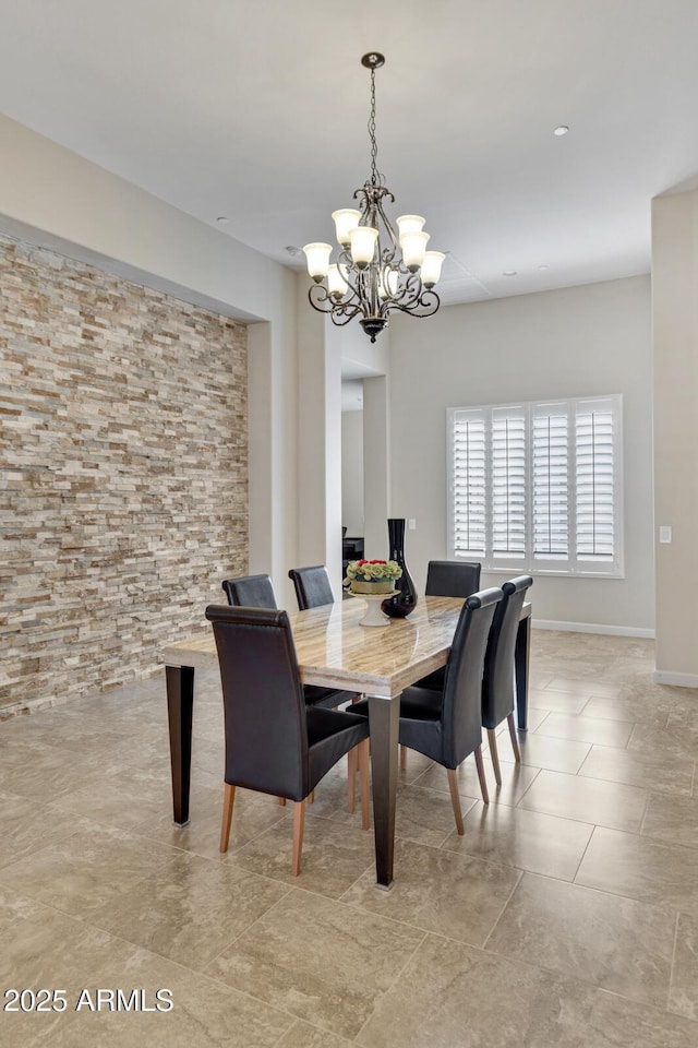 dining space featuring baseboards, a notable chandelier, and light tile patterned flooring