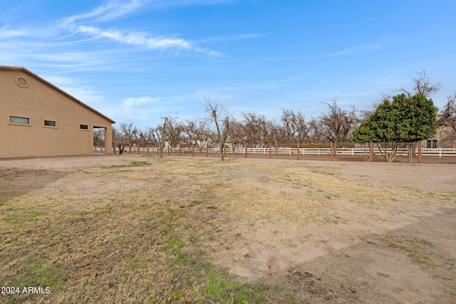 view of yard featuring a rural view and fence