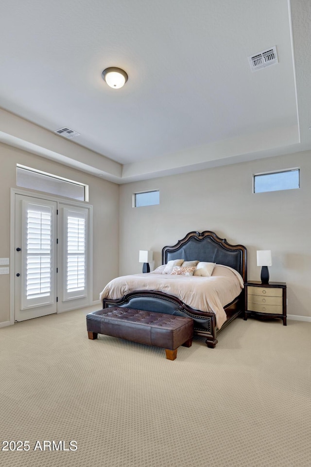 bedroom featuring baseboards, visible vents, and light colored carpet