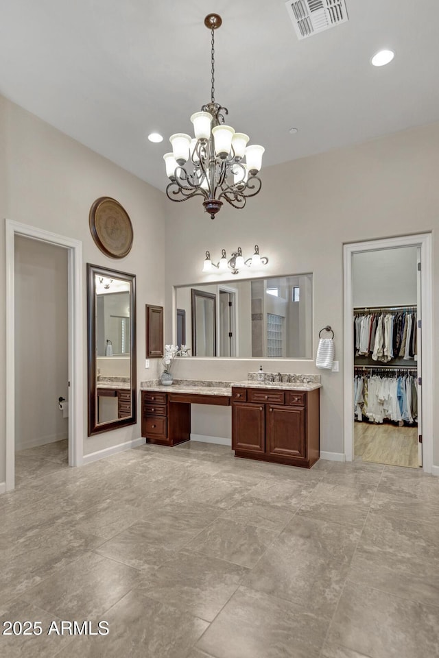 bathroom featuring recessed lighting, vanity, baseboards, visible vents, and an inviting chandelier