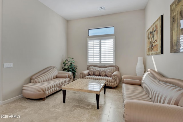 living room with visible vents, baseboards, and light tile patterned flooring