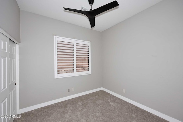 unfurnished bedroom featuring visible vents, carpet, a closet, and baseboards