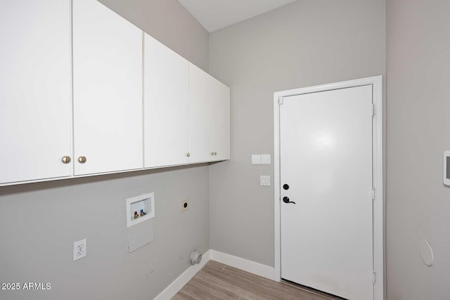 washroom with light wood-type flooring, washer hookup, cabinet space, baseboards, and hookup for an electric dryer