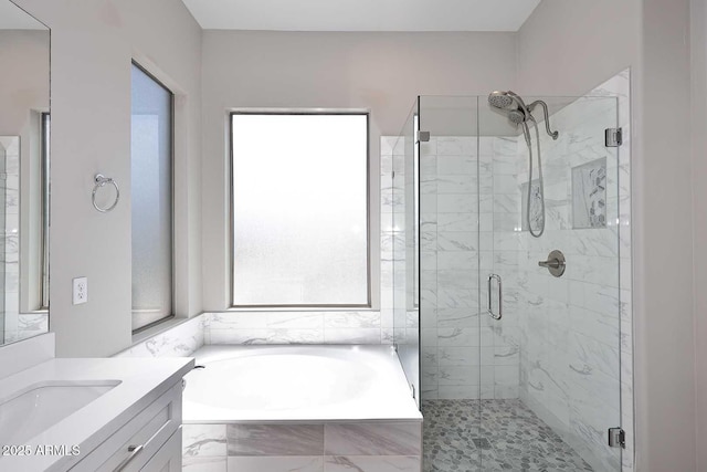 full bath with a bath, a shower stall, and vanity