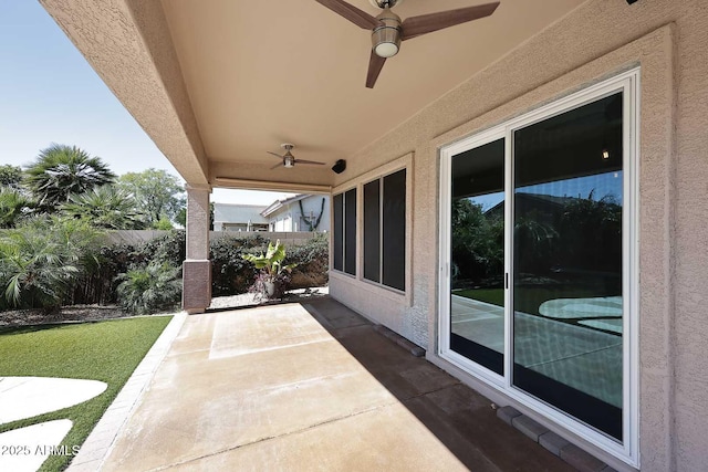 view of patio with a ceiling fan and fence
