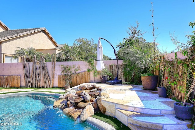 view of swimming pool featuring a fenced in pool, a patio, and a fenced backyard