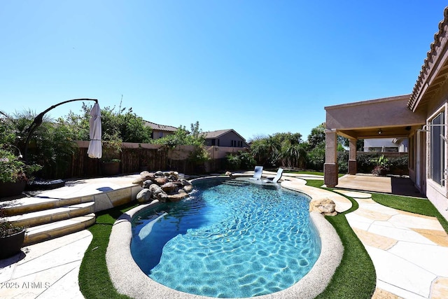 view of swimming pool featuring a patio area, a fenced backyard, and a fenced in pool