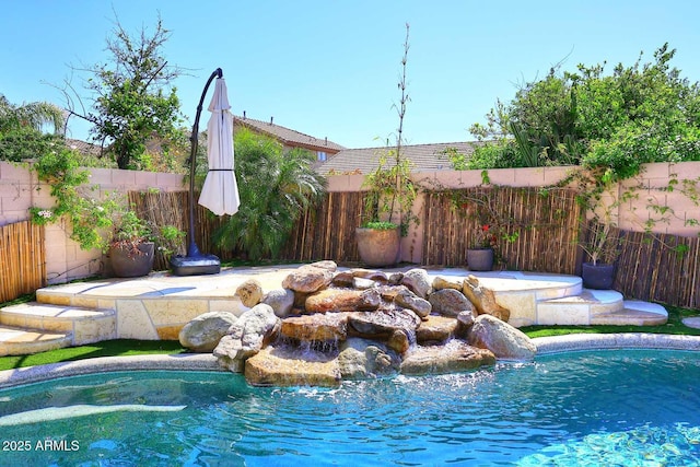 view of pool featuring a fenced in pool and a fenced backyard