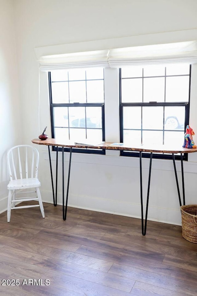 interior space featuring wood finished floors and baseboards