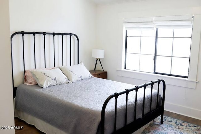 bedroom with wood finished floors and baseboards