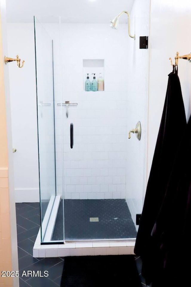 full bath featuring a stall shower and tile patterned flooring