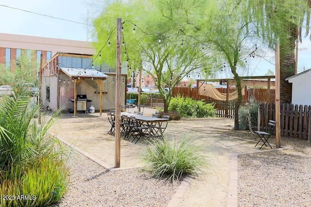 view of patio / terrace featuring an outbuilding and a fenced backyard