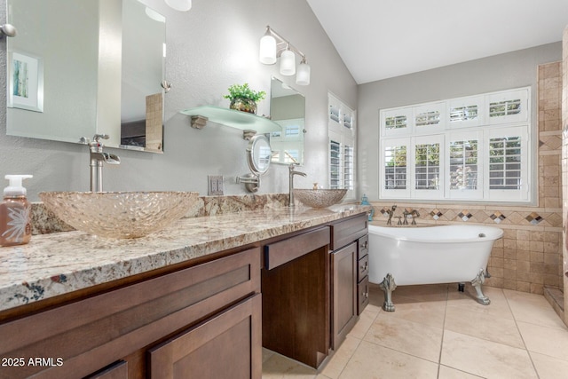 6918 W Villa Hermosa W, Glendale, AZ 85310 - full bath with vaulted ceiling, a freestanding bath, double vanity, tile patterned floors, and tile walls