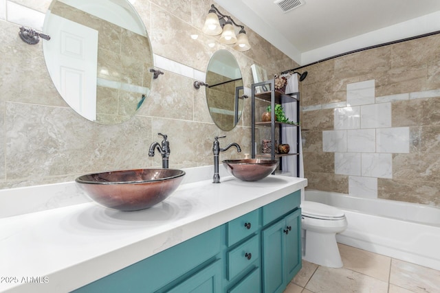 6918 W Villa Hermosa W, Glendale, AZ 85310 - full bathroom featuring double vanity, shower / tub combination, tile patterned flooring, tile walls, and decorative backsplash