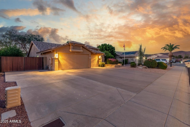 6918 W Villa Hermosa W, Glendale, AZ 85310 - ranch-style house with roof mounted solar panels, a garage, stucco siding, and concrete driveway