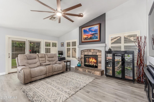 6918 W Villa Hermosa W, Glendale, AZ 85310 - living room featuring a stone fireplace, a ceiling fan, wood finished floors, and high vaulted ceiling