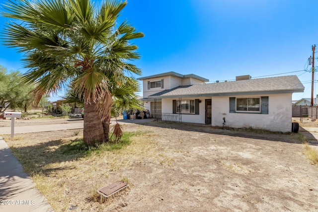 9408 N 15th St, Phoenix, AZ 85020 - view of front of house featuring concrete block siding, covered porch, and a shingled roof