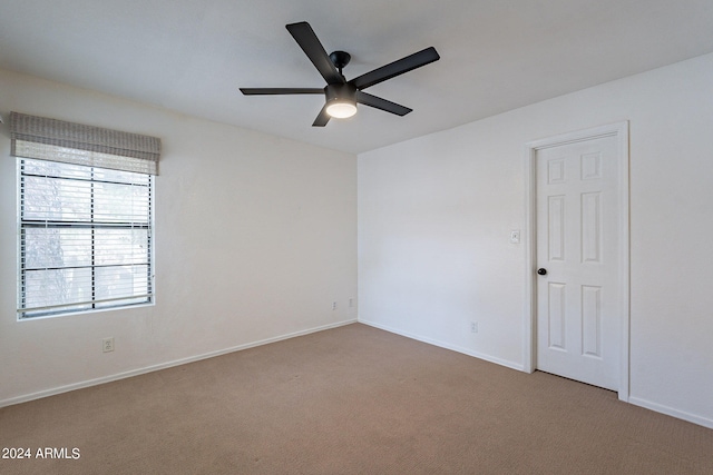 spare room featuring ceiling fan and carpet