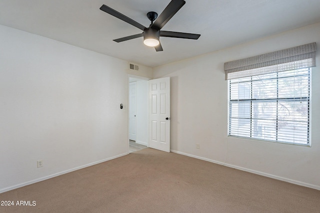 carpeted empty room with ceiling fan