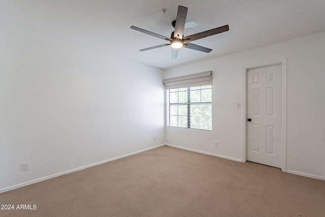 unfurnished room with ceiling fan and light carpet