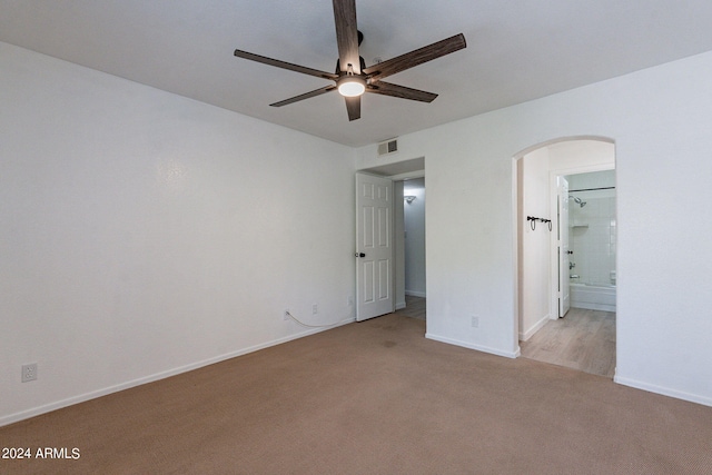 carpeted empty room featuring ceiling fan