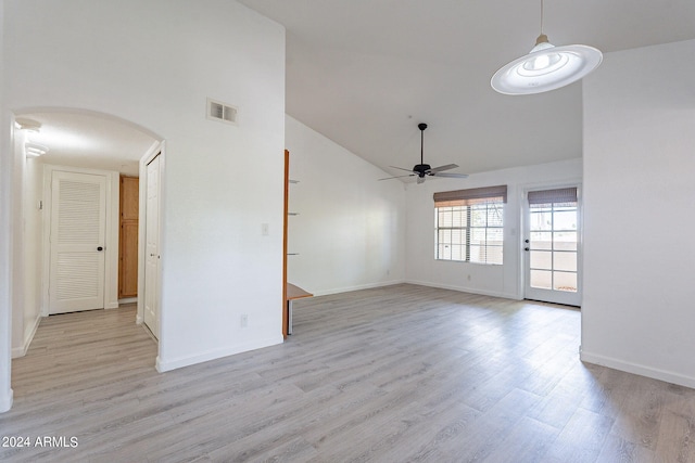 spare room featuring light hardwood / wood-style floors, high vaulted ceiling, and ceiling fan