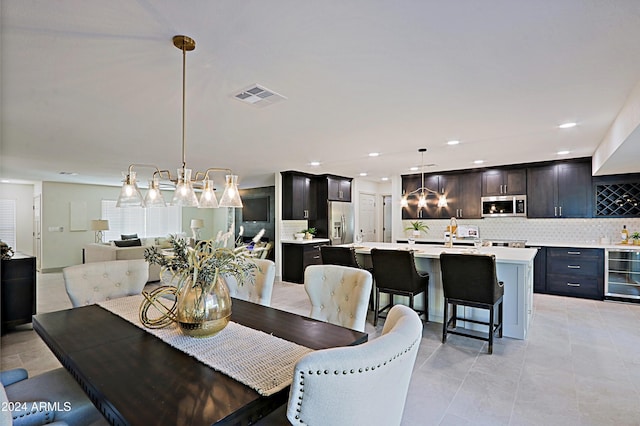 tiled dining area with wine cooler and sink