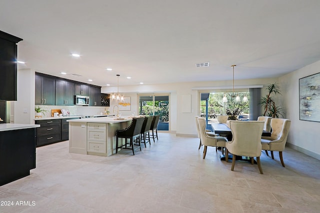 dining space featuring a notable chandelier and sink