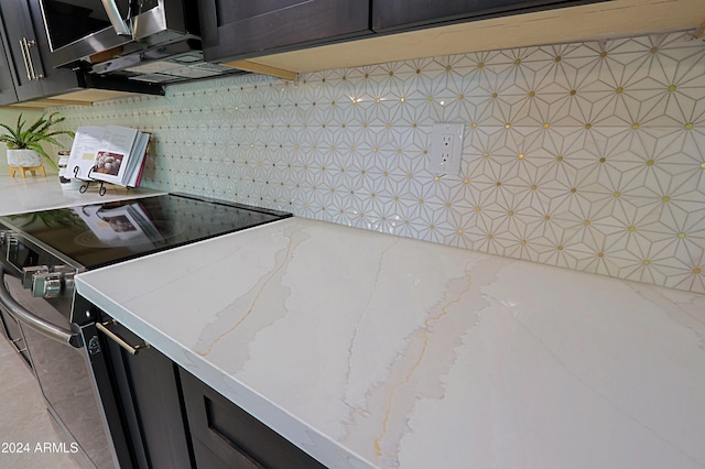 kitchen with backsplash, light stone counters, and stainless steel range with electric cooktop