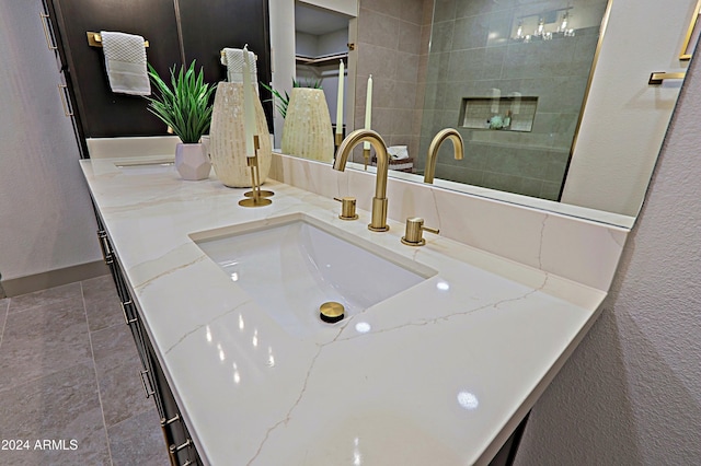 bathroom featuring tile patterned flooring and vanity