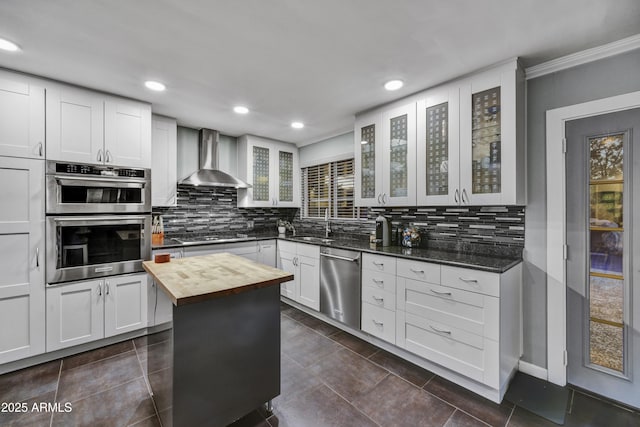 4610 N 14th Ave, Phoenix, AZ 85013 - kitchen with stainless steel appliances, wooden counters, wall chimney range hood, tasteful backsplash, and ornamental molding